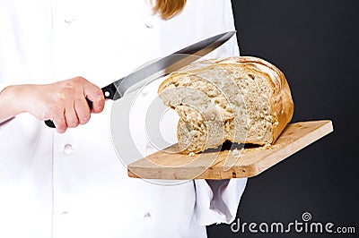 Female hands slicing home-made bread Stock Photo