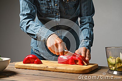 Female hands slicing bell pepper Stock Photo
