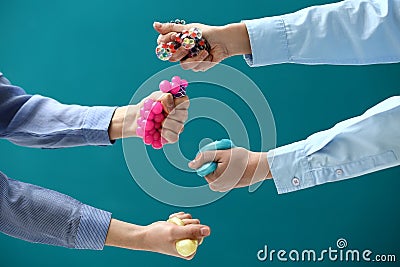 Female hands squeezing stress balls on color background Stock Photo