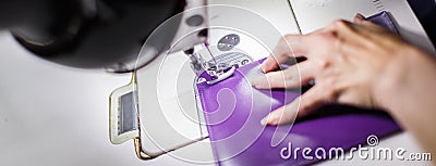 Female hands stitching a purse Stock Photo