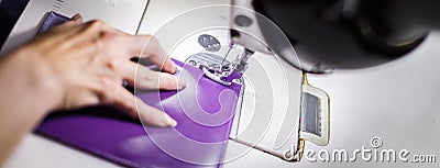 Female hands stitching a purse Stock Photo