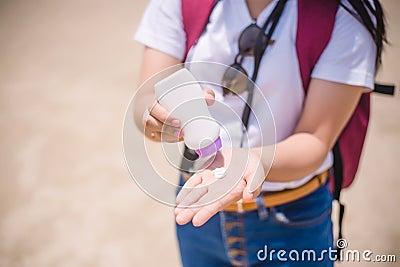 Female hands with sun protection cream at the beach. Skin care concep Stock Photo