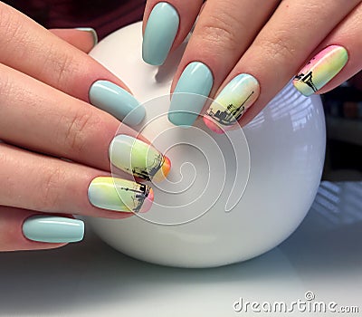 Female hands with a turquoise manicure and a painted ship. interesting and fashionable design Stock Photo