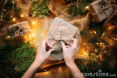 Female hands tying holiday craft gift box Stock Photo