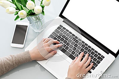 Female hands typing laptop keyboard with screen on tabl Stock Photo