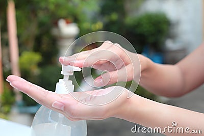 Female hands using gel pump dispenser wash hand sanitizer. Stock Photo