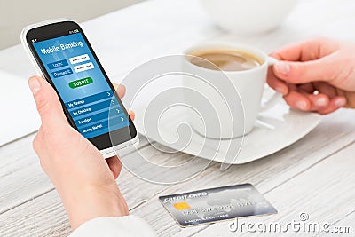 Female hands using mobile banking on smart phone. Stock Photo