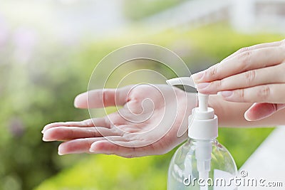 Female hands using wash hand sanitizer gel pump dispenser. Stock Photo