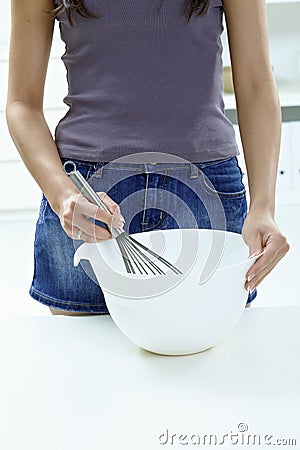 Female hands whipping eggs Stock Photo