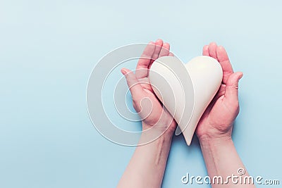Female hands with white porcelein heart Stock Photo