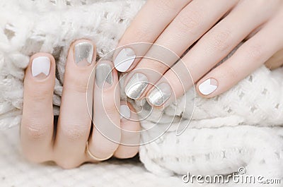 Female hands with white and silver nail design Stock Photo