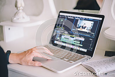 Female hands working on a laptop in a video editing program Stock Photo