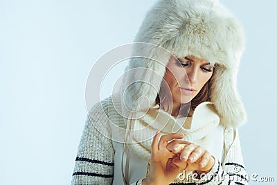 Female having cold allergy against winter light blue background Stock Photo