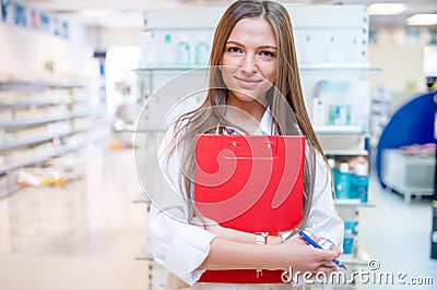 Female health care worker smiling in pharmacy Stock Photo