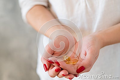 Female health vitamin deficiency hand supplements Stock Photo