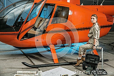 Beautiful female helicopter mechanic at work. feminism Stock Photo