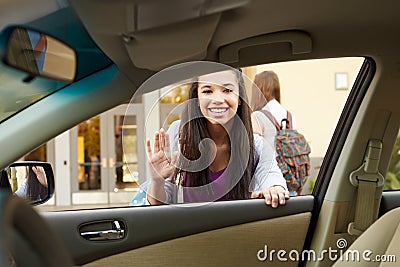 Female High School Student Being Dropped At School By Parent Stock Photo