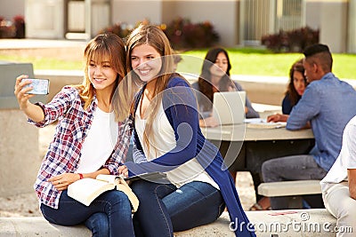 Female High School Students Taking Selfie On Campu Stock Photo