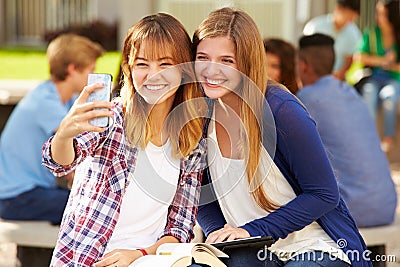 Female High School Students Taking Selfie On Campus Stock Photo