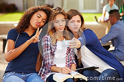 Female High School Students Taking Selfie On Campus Stock Photo
