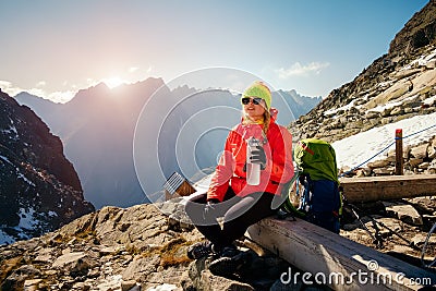 Female enjoy mountain landscape and drinking water after climbing Stock Photo