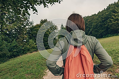 Female hiker walking on footpath outdoors Stock Photo