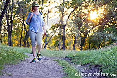 Female Hiker walking on Trail at Sunset Stock Photo