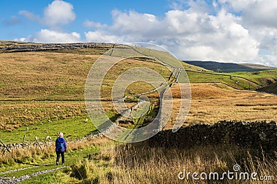 Female hill walker in Kingsdale in north Yorkshire Editorial Stock Photo