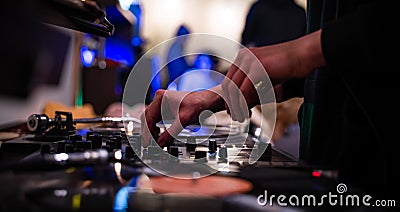 Female hip hop dj scratching vinyl records with music on party in night club.Professional disc jockey girl scratches old analog Stock Photo