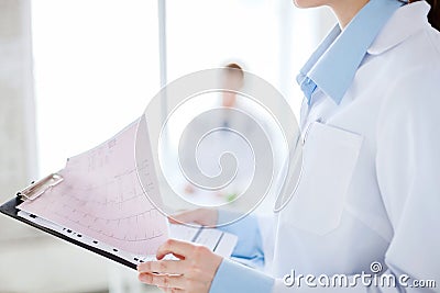 Female holding clipboard with cardiogram Stock Photo