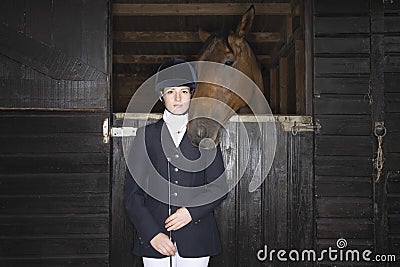 Female Horseback Rider With Horse In Stable Stock Photo