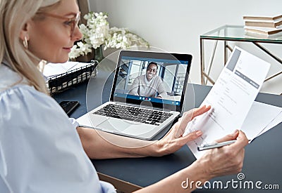 Female hr reading cv during online virtual job interview by video call. Stock Photo