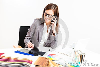 Female Interior Designer At Her Desk Stock Photo