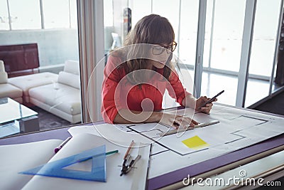 Female interior designer making plans on papers Stock Photo