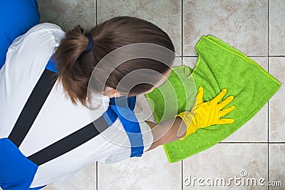 Female janitor in workwear cleaning floors Stock Photo