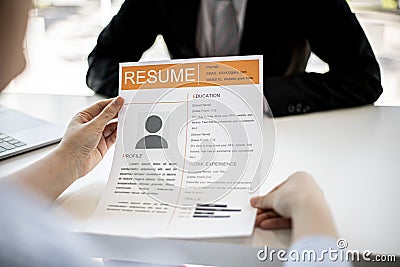 Female job applicants presenting a resume in the hands of a manager. Stock Photo