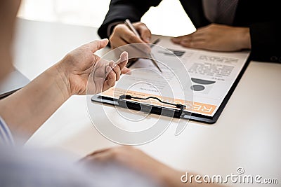 Female job applicants presenting a resume in the hands of a manager Stock Photo