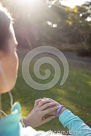 Female jogger checking her fitness band Stock Photo