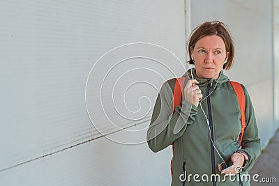 Female jogger talking on mobile phone handsfree Stock Photo