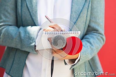 Female journalist or TV reporter at news event. Journalism concept. Stock Photo