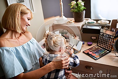 Female kid is amusing with make up Stock Photo