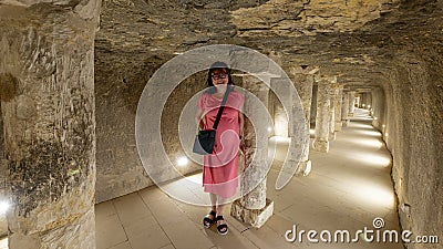 Female Korean tourist and stone columns reinforcing the passageway from the 2nd entrance on the south side of the Djoser pyramid. Stock Photo