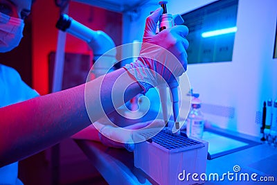 Female laboratory assistant in process of preparingbiomaterial for freezing Stock Photo