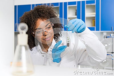 Female Laboratory Scientist Examining Plant Sample In Test Tube, Work In Genetics Lab Stock Photo