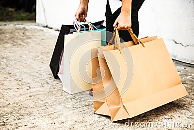 Female Lady carrying Colorful Shopping Bags Concept. Wrong posture, back bending, bad ergonomics Stock Photo