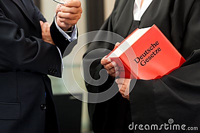 Female lawyer with civil law code and client Stock Photo