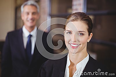 Female lawyer smiling while male colleague in background Stock Photo