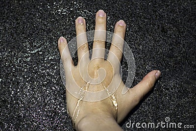 Female left hand on water statue. Refreshes with cold water during hot weather, cooling down in the heat, warm summer Stock Photo