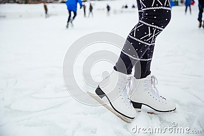Female legs in ice skates Stock Photo
