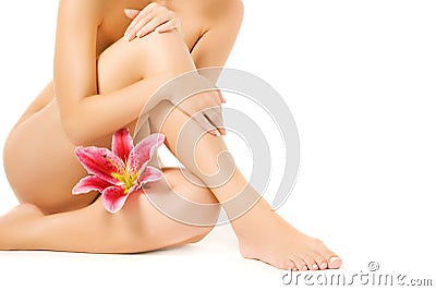 Female legs with pink lily Stock Photo